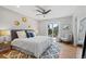 Cozy main bedroom featuring a large bed, stylish decor, and private balcony access at 2155 S Deframe St, Lakewood, CO 80228