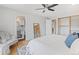 Bedroom with hardwood floor, a ceiling fan, and a view of the en-suite bathroom at 2155 S Deframe St, Lakewood, CO 80228