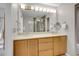 Bathroom with dual sinks, large mirror, and modern fixtures at 2716 W Greens Dr, Littleton, CO 80123