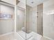 Modern bathroom showcasing a glass-enclosed shower with seating and sleek tiling at 2716 W Greens Dr, Littleton, CO 80123
