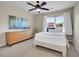 Cozy bedroom featuring a window view, modern dresser and minimalist décor at 2716 W Greens Dr, Littleton, CO 80123