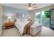 Bright bedroom featuring a ceiling fan, balcony access, and a comfortable bed at 2716 W Greens Dr, Littleton, CO 80123
