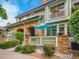 Beautiful townhome showcasing brick accents, manicured landscaping and a welcoming patio area at 2716 W Greens Dr, Littleton, CO 80123