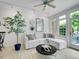 Bright living room with hardwood flooring, large windows, and a comfortable white sofa at 2716 W Greens Dr, Littleton, CO 80123