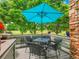 Relax on the deck with a grill, table, and chairs under a bright blue umbrella at 2716 W Greens Dr, Littleton, CO 80123