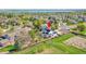 Aerial view of home showing landscaping, patio, solar panels and proximity to open space and lake at 12408 W 83Rd Ave, Arvada, CO 80005