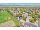 Aerial view of the house and property showing proximity to open space, mature trees, and 3-car garage at 12408 W 83Rd Ave, Arvada, CO 80005