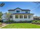Beautiful backyard with lush green grass, mature trees, and tasteful landscaping at 12408 W 83Rd Ave, Arvada, CO 80005