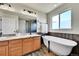 Beautiful bathroom featuring a single sink, granite countertops, a freestanding tub, and a luxurious walk-in shower at 12408 W 83Rd Ave, Arvada, CO 80005