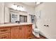Well-lit bathroom with a wood vanity, ample storage, and a shower at 12408 W 83Rd Ave, Arvada, CO 80005