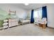 Serene Bedroom with mountain-themed accent wall, crib, changing table, and a comfortable rocking chair near a window at 12408 W 83Rd Ave, Arvada, CO 80005