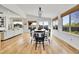 Dining room with wood floors, black dining set, and plenty of natural light at 12408 W 83Rd Ave, Arvada, CO 80005