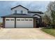 Charming two-story home with a three-car garage, brick accents, solar panels, and manicured landscaping at 12408 W 83Rd Ave, Arvada, CO 80005