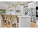 Bright kitchen with white cabinetry, stainless steel appliances, and a central island with counter seating at 12408 W 83Rd Ave, Arvada, CO 80005
