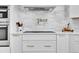 Close up of modern kitchen with stainless steel appliances, tile backsplash, and pot filler faucet at 12408 W 83Rd Ave, Arvada, CO 80005