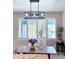 Inviting dining room with large windows and modern chandelier at 14248 E Hampden Ave, Aurora, CO 80014