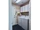 Functional laundry room featuring a washer, dryer, and plenty of storage at 14248 E Hampden Ave, Aurora, CO 80014