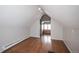 Finished attic space with hardwood flooring, a window, and recessed lighting at 136 W Maple Ave, Denver, CO 80223