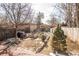 Landscaped backyard featuring raised garden beds, brick patio, and detached storage shed at 136 W Maple Ave, Denver, CO 80223