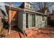 Brick patio and sliding glass door of home's rear exterior at 136 W Maple Ave, Denver, CO 80223