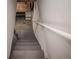 Stairway down to basement with gray painted steps and white handrail at 136 W Maple Ave, Denver, CO 80223