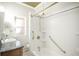 Bathroom featuring granite countertops, white tile, gold fixtures, and blue accents at 136 W Maple Ave, Denver, CO 80223