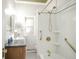 Bright bathroom with granite countertops, tiled shower and gold fixtures at 136 W Maple Ave, Denver, CO 80223