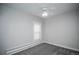 Neutral bedroom with gray carpet, a window, and a white ceiling fan at 136 W Maple Ave, Denver, CO 80223