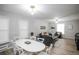 Open concept living and dining area with hardwood floors, lots of natural light, and modern décor at 136 W Maple Ave, Denver, CO 80223