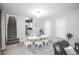 Bright dining area with a modern white table, seating for six, and seamless flow into the living area at 136 W Maple Ave, Denver, CO 80223