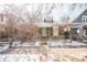 Charming brick home with a cozy front porch and a well-maintained yard, partially covered in winter snow at 136 W Maple Ave, Denver, CO 80223