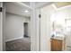 Hallway with bedroom and bathroom including gray carpet and a sink with granite countertop at 136 W Maple Ave, Denver, CO 80223