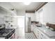 Well-lit kitchen featuring granite countertops, modern stainless steel appliances, and ample cabinet space at 136 W Maple Ave, Denver, CO 80223