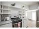 Stylish kitchen showcasing modern appliances, open shelving, and a bright, airy atmosphere with hardwood flooring at 136 W Maple Ave, Denver, CO 80223