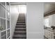 Carpeted staircase leading to the upper level, adjacent to the kitchen at 136 W Maple Ave, Denver, CO 80223