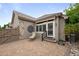 Backyard patio with awning, paved bricks, lush landscaping and stylish seating at 6900 W Grant Ranch Blvd # 88, Denver, CO 80123
