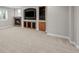 Finished basement featuring a fireplace, TV, and custom built-ins for storage and entertainment at 6900 W Grant Ranch Blvd # 88, Denver, CO 80123