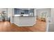 Modern kitchen area with hardwood floors, stainless steel appliances, and a breakfast bar at 6900 W Grant Ranch Blvd # 88, Denver, CO 80123