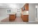 Basement kitchenette offers a tiled floor, granite counters, sink, and cabinetry at 6900 W Grant Ranch Blvd # 88, Denver, CO 80123