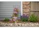 Exterior landscaping with flowering bushes, plants, flowers, and stone border at 6900 W Grant Ranch Blvd # 88, Denver, CO 80123