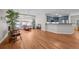 Open-concept living room with hardwood floors, a fireplace, and seamless flow to the kitchen at 6900 W Grant Ranch Blvd # 88, Denver, CO 80123