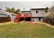 Back exterior view of the house with a deck and yard at 17968 E Bethany Pl, Aurora, CO 80013