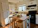 Bright kitchen with island and white cabinets at 17968 E Bethany Pl, Aurora, CO 80013