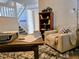 Cozy living room featuring comfortable seating and a charming bookshelf at 17968 E Bethany Pl, Aurora, CO 80013