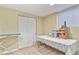 Unfinished basement features open space with closet, window, and table at 5317 W Iliff Dr # 101, Lakewood, CO 80227