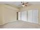 Spacious bedroom with carpet floors, ceiling fan, and closet with sliding doors at 5317 W Iliff Dr # 101, Lakewood, CO 80227