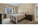 Neutral bedroom with light carpet, large window, vaulted ceiling and ensuite bathroom at 5317 W Iliff Dr # 101, Lakewood, CO 80227