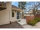 Inviting home entrance featuring a secure screen door and a small patio area at 5317 W Iliff Dr # 101, Lakewood, CO 80227