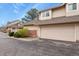 Exterior view of home with a garage and manicured lawn with surrounding bushes at 5317 W Iliff Dr # 101, Lakewood, CO 80227