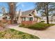 Charming townhome with manicured landscaping, brick accents, and a private patio at 5317 W Iliff Dr # 101, Lakewood, CO 80227